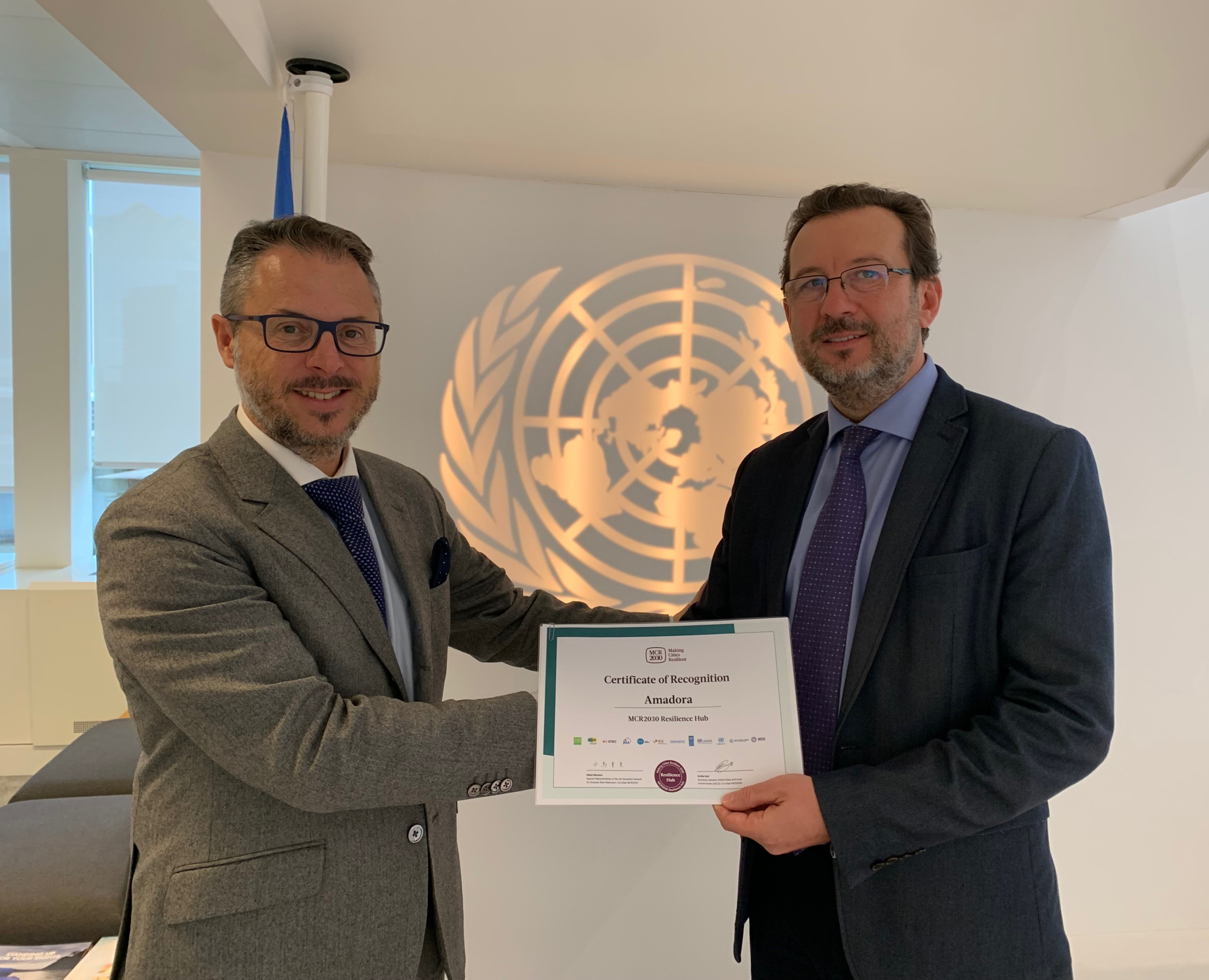 Mr. Luis Lopes, Amadora City Councillor, is presented the MCR2030 Certificate of Recognition by Mr. Octavian Bivol, Chief of UNDRR's Regional Office for Europe & Central Asia