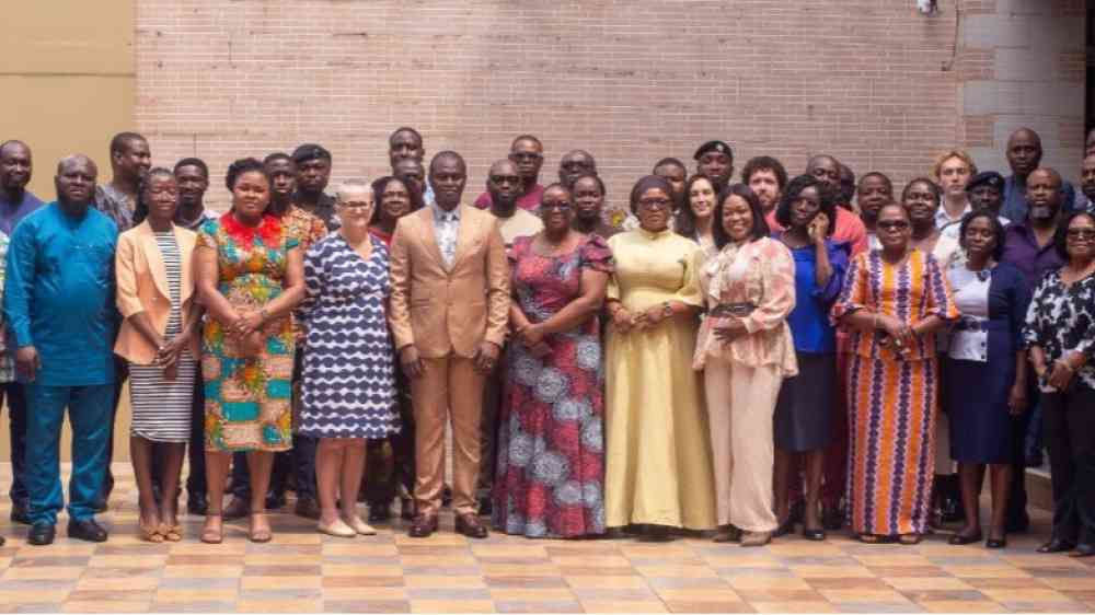 Group photo of Government ministries, local authorities, and partners. All people photographed are standing